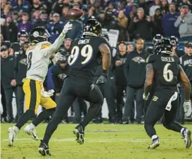  ?? JERRY JACKSON/BALTIMORE SUN ?? Steelers quarterbac­k Kenny Pickett (8) throws a touchdown pass in the final minute of a win over the Ravens on Sunday night.