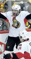  ?? GENE J. PUSKAR/THE ASSOCIATED PRESS ?? Ottawa Senators’ Bobby Ryan celebrates with teammates after scoring the game-winning goal against the Pittsburgh Penguins during the overtime period of Game 1, on Saturday.