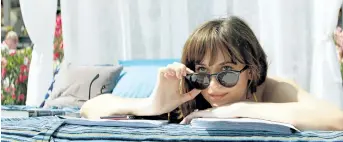  ?? MOVIE STILLS ?? Dakota Johnson, above, and Jamie Dornan worked with sex toy experts on the Fifty Shades films, so they would look like they would know what they were doing during steamy scenes.