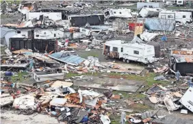  ?? DORAL CHENOWETH/THE COLUMBUS DISPATCH ?? The worst damage was reported in Ohio, where the storms killed at least three people and devastated the Indian Lake and Orchard Island communitie­s, about 70 miles northwest of Columbus, Logan County Sheriff Randy Dodds said at a news conference Friday.