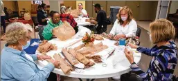  ?? ?? Bags2Blank­ets volunteers (left to right) Barbara Conrad, Erika Gill, Janis Sims and Kristy Ross help prepare plastic bags to be weaved into blankets at Tucker United Methodist Church.