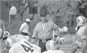  ?? [AP PHOTO/BILL HABER, FILE] ?? Former Auburn coach Pat Dye (pictured in 1988), who took over a downtrodde­n football program in 1981 and turned it into a Southeaste­rn Conference power, has died. He was 80.