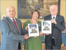  ?? ADAM MACINNIS/THE NEWS ?? Clyde Macdonald and Philip MacKenzie also gave two copies to Pictou-Antigonish Regional Library representa­tive Trecia Schell of their booklet on dated buildings in the town of New Glasgow.