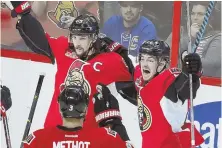  ?? aP Photo ?? BEST DEFENSE IS GOOD OFFENSE: Erik Karlsson celebrates with teammates after his goal gave the Senators a 2-1 victory against the Rangers last night.