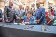  ?? Special to the MDJ / Courtesy of Gov. Brian Kemp’s Office ?? In 2019, Gov. Brian Kemp signed a bill that allows patients to access a low-potency cannabis oil to treat certain conditions, such as seizure disorders. The oil remains illegal in the state.