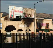  ?? RANDY VAZQUEZ — STAFF ARCHIVES ?? A billboard prompting the use of face masks sits atop a store on North White Road in San Jose in December 2020.