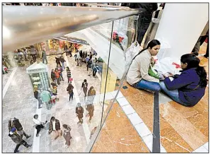  ??  ?? Shoppers take a break at a mall in Paramus, N. J. Real estate investment trusts have fallen behind the broader market this year, held back by store closures and other woes.