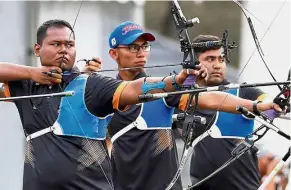  ??  ?? On target: Malaysian men’s recurve archers (from left) Haziq Kamaruddin, Muhd Akmal Nor Hasrin and Khairul Anuar Mohamed posted a total of 1,990 points to reach the knockout stage in Dhaka yesterday.