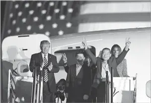  ??  ?? From left, President Donald Trump applauds for Tony Kim, Kim Hak Song and Kim Dong Chul as they arrive at Andrews Air Force Base in Maryland on Thursday. First lady Melania Trump was also there to greet the trio released from captivity in North Korea.