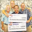  ?? Contribute­d Photo / ?? Bruce Rosa poses with his winnings, two friends and his soninlaw on Tuesday.
