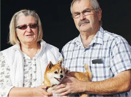  ?? AL CHAREST ?? Naudia and Leonard Sztym hold their dog Willow. The Sztyms lost two other dogs, Jasper and Casey, after the dogs were allegedly mauled during a stay at a Red Deer kennel last week.