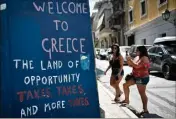  ??  ?? Graffiti contre la politique fiscale, dans le centre d’Athènes. Les chiffres sont bien meilleurs qu’en , mais le quotidien des Grecs reste très dur. (Photo AFP)