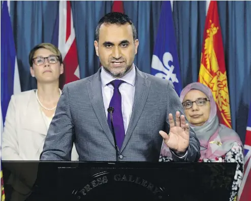  ?? JUSTIN TANG / THE CANADIAN PRESS FILES ?? National Council of Canadian Muslims executive director Ihsaan Gardee, centre, speaks in Ottawa.