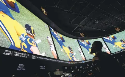 ??  ?? At the Westgate Superbook in Las Vegas, fans watch the Super Bowl. Nevada’s neighbor California is unlikely to legalize sports betting.