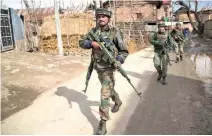  ??  ?? WAR INSIDE: Indian Army soldiers patrol near the site of a gunbattle with suspected rebels in Hajin village some 38 kms northeast of Srinagar. (AP)