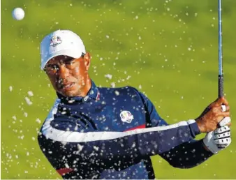  ?? AP PHOTO/FRANCOIS MORI ?? Tiger Woods plays from a bunker on the third hole during a practice session at Le Golf National in Guyancourt, outside Paris, France, on Tuesday. The 42nd Ryder Cup will begin Friday at Le Golf National.