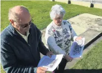  ?? PHOTO: ALEXIA JOHNSTON ?? Drawing blanks . . . Rowena Owens and her husband Ken look at old newspaper articles featuring the Howitzer wartime field gun Mrs Owens gave to Clyde. The concrete slab where it usually sits is now empty after the gun was removed by members of the RSA without consulting Mrs Owens.