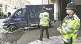  ??  ?? A police van believed to be carrying Michael Adebowale, a suspect in the murder of soldier Lee Rigby, speeds as it leaves the Westminste­r Magistrate­s Court on Thursday.