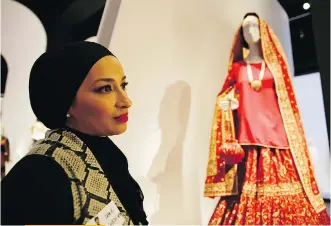  ?? ERIC RISBERG/THE ASSOCIATED PRESS ?? Stylist Saba Ali talks about her Pakistani wedding ensemble of red silk in the exhibit Contempora­ry Muslim Fashions at the M. H. de Young Memorial Museum in San Francisco.
