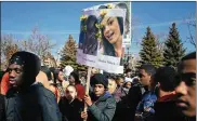  ?? ALYSSA SCHUKAR / NEW YORK TIMES ?? Zechariah Stepney carries a sign honoring the 17 who died in the Feb. 14 Florida school shooting as he and other Perspectiv­es High School of Technology students walked out Wednesday in Chicago.