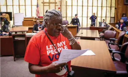  ?? Photograph: Zak Bennett/AFP via Getty Images ?? Carmen Brown weeps as she walks away holding a paper restoring her right to vote during a special court hearing aimed at restoring the right to vote last year in Miami.