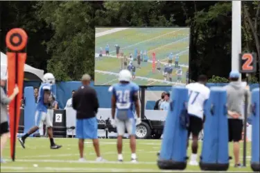  ?? CARLOS OSORIO — THE ASSOCIATED PRESS ?? In this photo, Detroit Lions players stand on the sideline opposite a monitor highlighti­ng the previous play during NFL football practice in Allen Park, Mich. The Lions are among the teams in the league making instant replay available to make quick correction­s and observatio­ns.