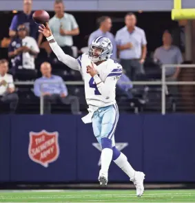  ?? KEVIN JAIRAJ/USA TODAY SPORTS ?? Cowboys quarterbac­k Dak Prescott makes a leaping throw against the Eagles on Monday night in Arlington, Texas.
