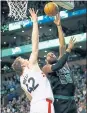  ?? MICHAEL DWYER — THE ASSOCIATED PRESS ?? The Celtics’ Greg Monroe shoots against the Raptors’ Jakob Poeltl Saturday.