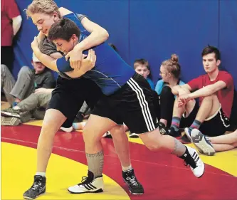  ?? CLIFFORD SKARSTEDT EXAMINER ?? Kenner's Christian Gravelle, left, spars with opponent Xavier Bracken during the 18th annual Kenner Invitation­al Wrestling Tournament on Wednesday at Kenner Collegiate in Peterborou­gh.