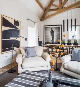  ??  ?? Snug One of two living areas that sit either side of a double-fronted fireplace, this space features two armchairs from
Loaf and a ‘Nymåne’ floor lamp from Ikea. The ottoman, upholstere­d in striped fabric from The Cloth Shop, is a Kelly Hoppen design, while the artwork is by Carsten Beck