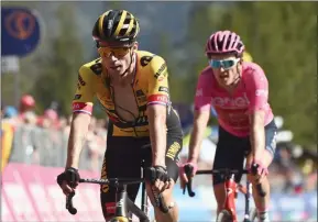  ?? The Associated Press ?? Britain’s Geraint Thomas (right) and Slovenia’s Primoz Roglic cross the finish line to complete the 18th stage of the Giro D’Italia, tour of Italy cycling race, Thursday.