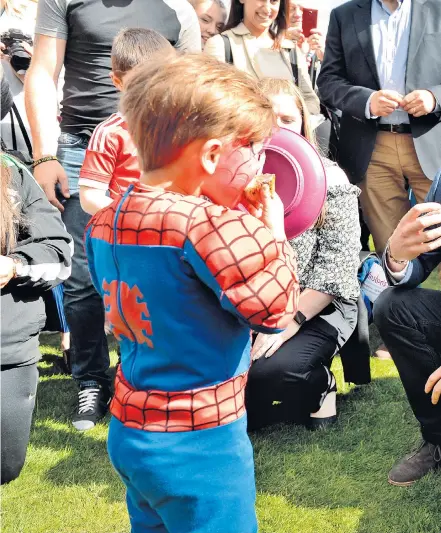  ??  ?? Prince Harry gets into the spirit with a youngster at the Party at the Palace