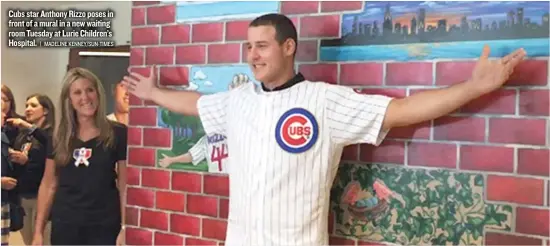  ?? | MADELINE KENNEY/ SUN- TIMES ?? Cubs star Anthony Rizzo poses in front of a mural in a new waiting room Tuesday at Lurie Children’s Hospital.