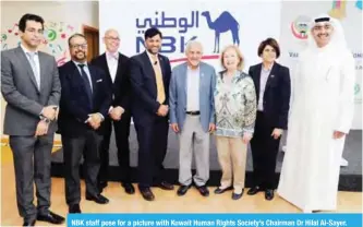  ??  ?? NBK staff pose for a picture with Kuwait Human Rights Society’s Chairman Dr Hilal Al-Sayer.