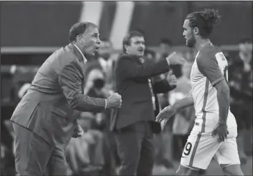  ?? The Associated Press ?? IN THE ARENA: United States head coach Bruce Arena calls out to his team as Graham Zusi steps off the field during the Americans’ CONCACAF Gold Cup semifinal victory Saturday in Arlington, Texas. Arena goes for his third Gold Cup title as a coach when...