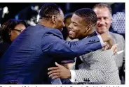  ?? FRANK FRANKLIN II / ASSOCIATED PRESS ?? Family and friends congratula­te Dennis Smith Jr. (right) after the Mavericks took him with the ninth pick in the NBA draft Thursday night.