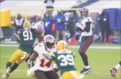  ?? Stacy Revere / TNS ?? Buccaneers quarterbac­k Tom Brady looks to pass in the first quarter against the Green Bay Packers during the NFC championsh­ip game on Sunday in Green Bay, Wis.