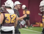  ??  ?? New ASU offensive coordinato­r Zak Hill instructs during spring practice on Monday at Kajikawa practice fields.