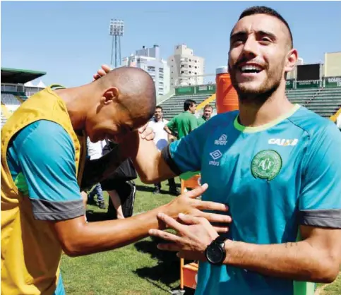  ??  ?? CHAPECO: Brazilian Chapecoens­e footballer Alan Ruschel (R), one of the survivors of the LaMia airplane crash in Colombia, jokes with Wellington Paulista after a training session at the Arena Conda stadium. — AFP