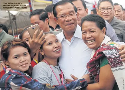  ??  ?? Prime Minister Hun Sen is welcomed by garment workers during a rally in Kandal province.