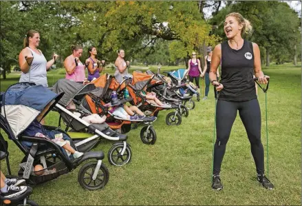  ?? JAY JANNER / AMERICAN-STATESMAN PHOTOS ?? Lisa Druxman, founder of Fit4Mom and Stroller Strides, leads a Stroller Strides class at Zilker Park in November.