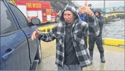  ?? JOE GIBBONS/THE TELEGRAM ?? Torbay fisherman Wayne Bradbury gives the thumbs-up at Tappers Cove in Torbay on Tuesday afternoon as he heads home with his wife and son after being cleared by Eastern Health paramedics. Three fellow fishermen came to his aid after he fell from his boat into the water earlier Tuesday.