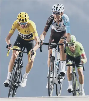  ??  ?? Chris Froome, left, battles with Rigoberto Uran, right, and Romain Bardet to get across the finish line during the 18th stage of the Tour de France yesterday.