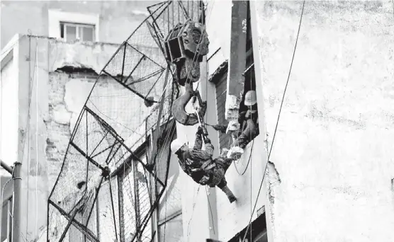  ?? JAVIER RÍOS ?? Brigadista­s ingresan por la ventana de un departamen­to en el multifamil­ar Taxqueña.