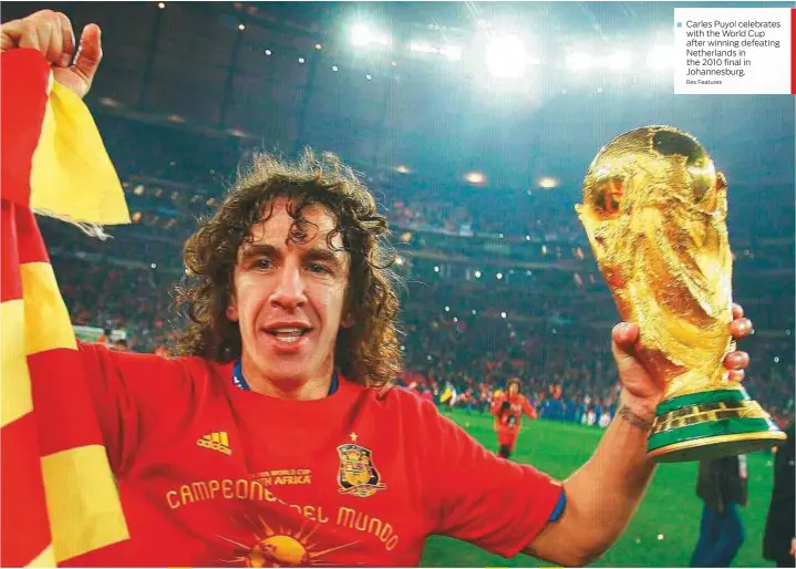  ?? Rex Features ?? Carles Puyol celebrates with the World Cup after winning defeating Netherland­s in the 2010 final in Johannesbu­rg.