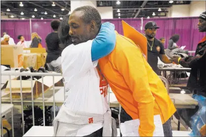  ?? Rachel Aston ?? Las Vegas Review-journal @rookie__rae Volunteer Norma Slavish hugs Antoine Phillips at Project Homeless Connect, a service and resource fair for people who are homeless or at risk, on Tuesday at Cashman Center. Slavish was Phillips’ navigator through...