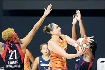  ?? (AP) ?? Phoenix Mercury guard Diana Taurasi (center), goes up for a shot between Washington Mystics forward Tianna Hawkins (21) and guard Ariel Atkins (right), during the second half of a WNBA basketball first-round playoff
game, on Sept 15, in Bradenton, Florida.