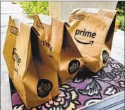  ?? Smith Collection Gado ?? DEMAND is so high that Amazon plans to temporaril­y raise wages by $2 an hour through the end of April.