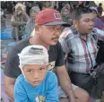  ??  ?? Earthquake survivor Ridwan Wahyudi sits with his family inside a shelter in Sambelia village on Lombok.