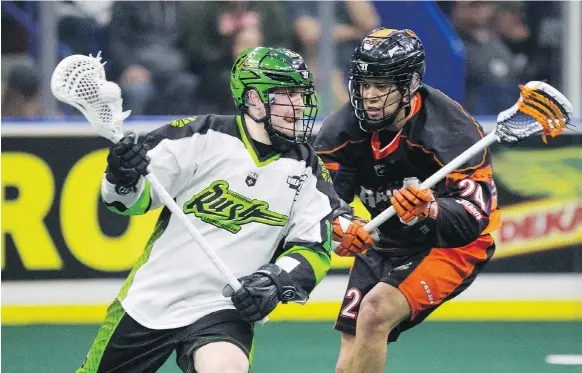  ?? KAYLE NEIS ?? Rush forward Robert Church pivots to move the ball past Buffalo Bandits forward Mitch Jones during the game at SaskTel Centre in Saskatoon late last month.